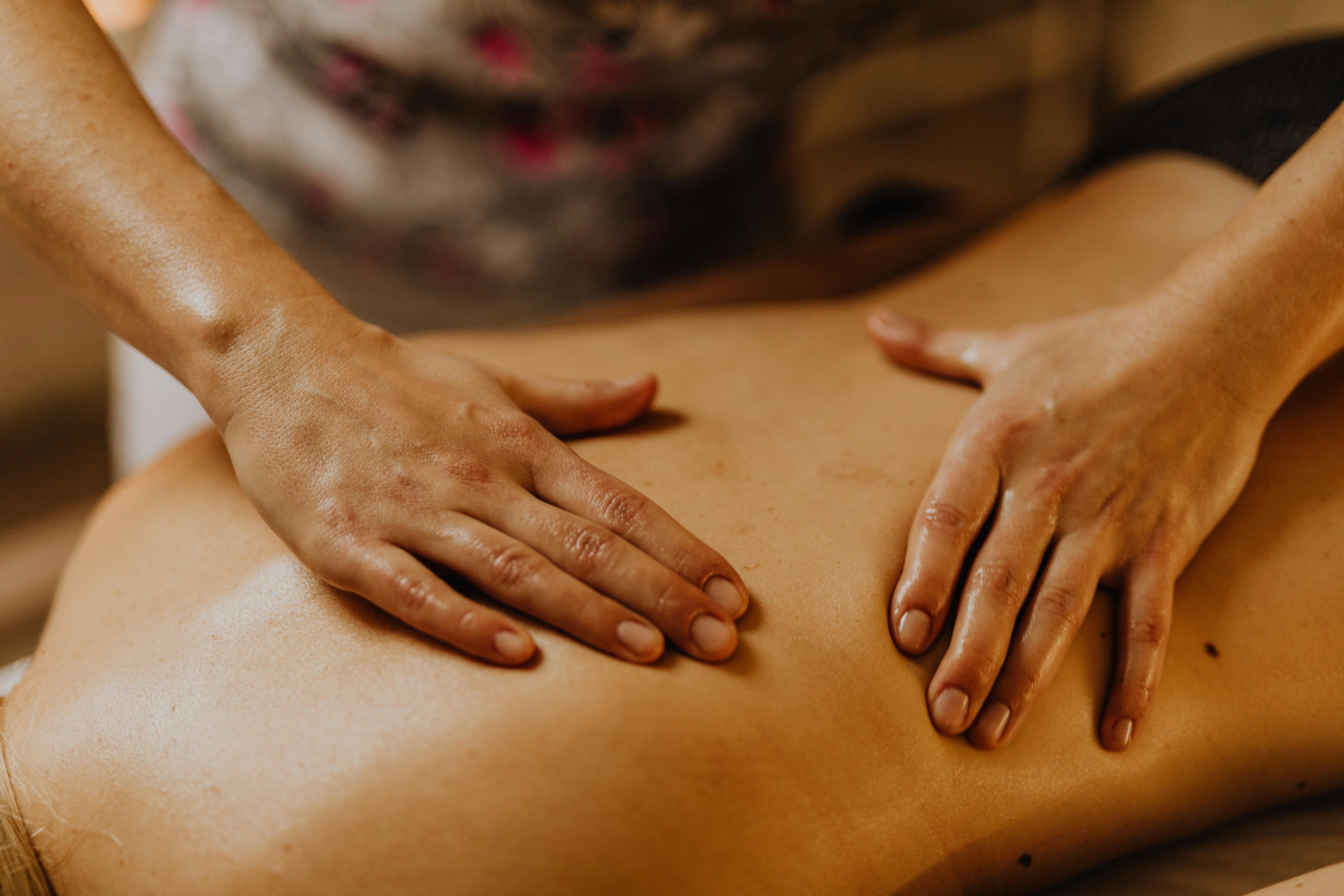 Klassisk ryggmassage med händer som arbetar över ryggen